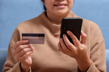 Poster - close up hand use credit card pay contactless online in mobile app shopping