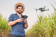 Young agricultural worker, agronomist, using drone for crop analysis, computerization, planting automation. Drone in agricultural use.