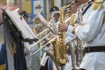 KOLKATA, WEST BENGAL , INDIA - JANUARY 17TH 2016 : Kolkata Police Force Officers, dressed in white and black suits, are playing band, using various musical instruments, in a winter morning.