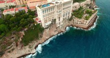 Aerial Tilt Up Shot Of Famous Museum Of Marine Sciences On Cliff, Drone Flying Forward Over Sea - Monaco
