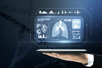 Wall Mural - Close up of businessman hand holding tablet with glowing medical hologram. Healthcare and digital transformation concept. Blurry dna helix in the background.