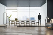 © Who is Danny - Attractive young european businessman standing in modern concrete office interior with wooden flooring, matte partition glass, furniture, equipment and city view with daylight. Worker and ceo concept.