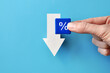 © fidaolga - The 'percentages' sign on the background of the down arrow. Interest reduction