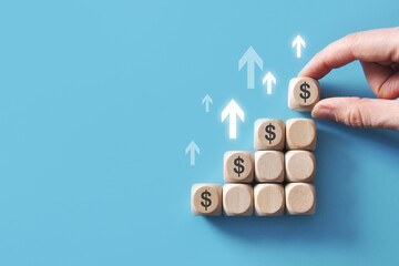 Wall Mural - Wooden cubes with a dollar pattern and up arrows. Symbol of the growth of the dollar