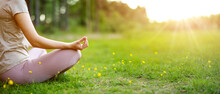 Woman Sitting In Active Wear In Lotus Position In Nature.