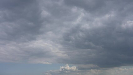 Wall Mural - sunset cloudy sky landscape. 4k video footage of grey and white fluffy huge clouds isolated on clear