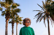 © Raul Mellado - young latin woman with glasses next to palm trees