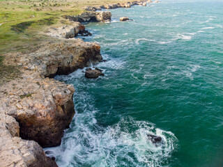 Aerial view of sea waves and fantastic cliffs, rocky coast. Tyulenovo, Bulgaria