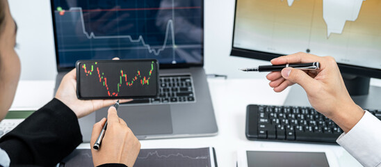 Aufkleber - Two business colleagues pointing stock data chart on smartphone to checking data stock market and discussion