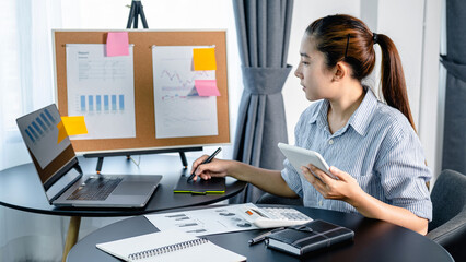 Poster - Business woman holding tablet and using digital tablet with laptop for investment planning of new business