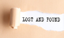 The Text LOST AND FOUND Appears On Torn Paper On White Background.