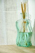 Glass bottle with room fragrance and bamboo diffuser sticks