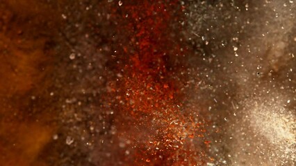 Super slow motion of exploding spices mix. Filmed on high speed cinema camera, 1000 fps. Speed ramp effect.