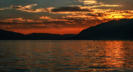 Wall Mural - Reflection of orange colorful sky on water surface of Adriatic sea in Montenegro