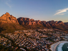 Aerial View Of Table Mountain And Camps Bay Shoreline At Sunset, Cape Town, South Africa.