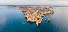 Panoramic Aerial View Of Ponta Da Piedade, A Scenic Rock Formation And Famous Boat Spot With Wild Cliffs Facing The Ocean In Lagos, Algarve Region, Portugal.