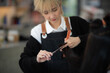 © chokniti - professional hairdresser person doing haircut for woman client in beauty fashion salon, hair care coiffure style concept, beautician female work with cut scissors to comb in barber, hairstylist tool
