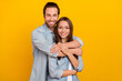 © deagreez - Photo of lovely young brown hairdo couple hug wear blue shirt isolated on yellow background