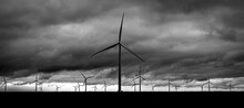 Grayscale Shot Of Wind Turbines In A Deserted Area