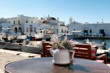 Flower Arrangement In Teapot On The Table Of A Taverna In Paros