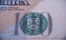 Closeup Shot Of The 100 Sign And The Green Seal On The 100$ US Dollars Bill