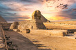 Giza, Egypt -  November 14, 2021: The Great Sphinx by the great ancient Pyramids of Giza, Egypt