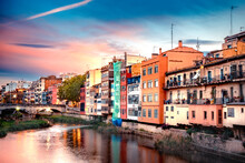 Beautiful View Of The Medieval City Of Girona Spain With Canal And Historic Colorful Buildings Seen At Sunset.