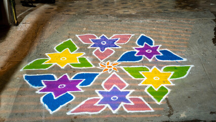 Sticker - Beautiful shot of cross dot kolam and colorful Stars with leaves on the grunge floor