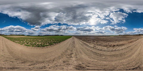 Wall Mural - full seamless spherical hdri 360 panorama view on no traffic gravel road among fields in summer day 