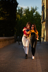 Wall Mural - Two teenager girls walking down the street.