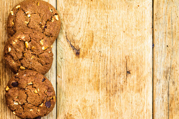 Wooden table with chocolate chip cookies for wallpaper and background