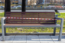 A Painted Bench In The Park On Which A Red Ribbon Is Tied. 
(Corrected)