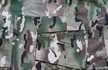 Camouflage army military fabric, with elements of pockets. Camouflage pattern background. Forest texture colors.