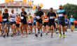© ChiccoDodiFC - Intentionally blurred group of athletes runners during foot race in the city on the asphalt road and sportswear