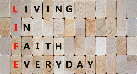 LIFE living in faith everyday symbol. Concept words LIFE living in faith everyday on wooden blocks on beautiful wooden background. Business LIFE living in faith everyday concept. Copy space.