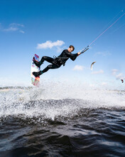 Young Kiteboarding Athlete Doing  Powerful Stunts In The Water, Lithuania