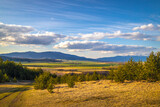 Fototapeta Na ścianę - Sunny spring rural landscape, valley of fields and meadows with mountains in the background. Turiec Valley in Slovakia, Europe.