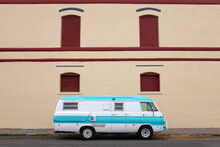 Vintage Camper In Front Tan Wall.