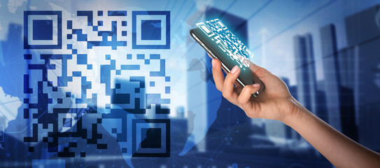 Double exposure of modern city and female hand holding smartphone with QR code on screen