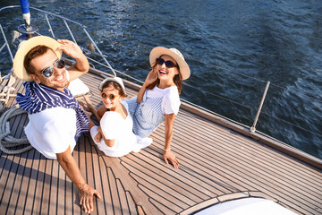 Wall Mural - Happy young family resting on yacht