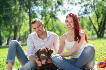 Canvas Print - Couple with a dog in the park