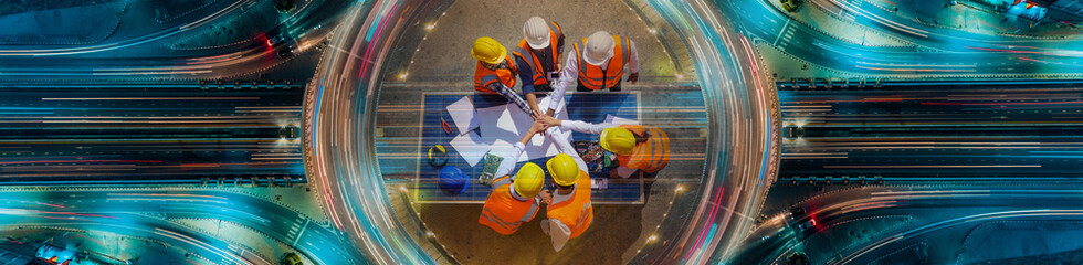 Top view of architectural engineer are standing with their hands together on solar panels and his blueprints  on construction site. meeting, Road traffic an important infrastructure