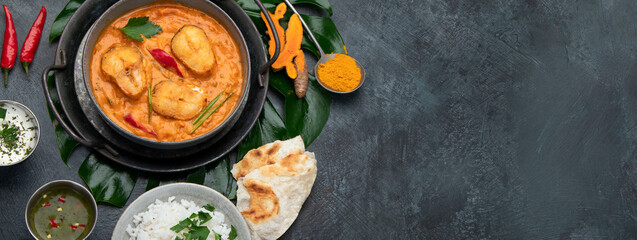 Kerala fish curry on dark background.