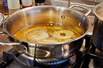 Sticker - Cooking apple pancake. Apple donut in boiling oil