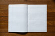 © wachiwit - Ruled paper notebook on wooden table