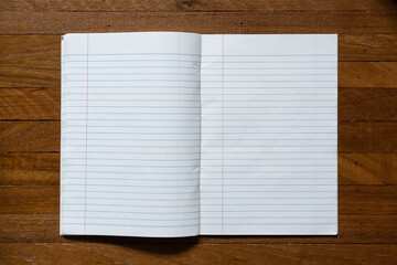 ruled paper notebook on wooden table