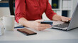 © DC Studio - Business woman using credit card to buy on online shopping from retail store, making internet payment for e commerce development. Sales consultant doing purchase with money transaction. Close up.