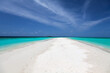 A walk on a long sandbank in Maldives looking to the horizon the sandbank give the sensation of vanishing point