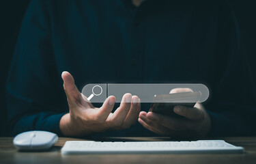 Wall Mural - The concept of using technology to search for information, a man's hand is using a smartphone to search for information on social media via the Internet online.