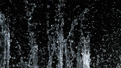 Wall Mural - Super slow motion of water splash on black background. Filmed on high speed cinema camera, 1000 fps.